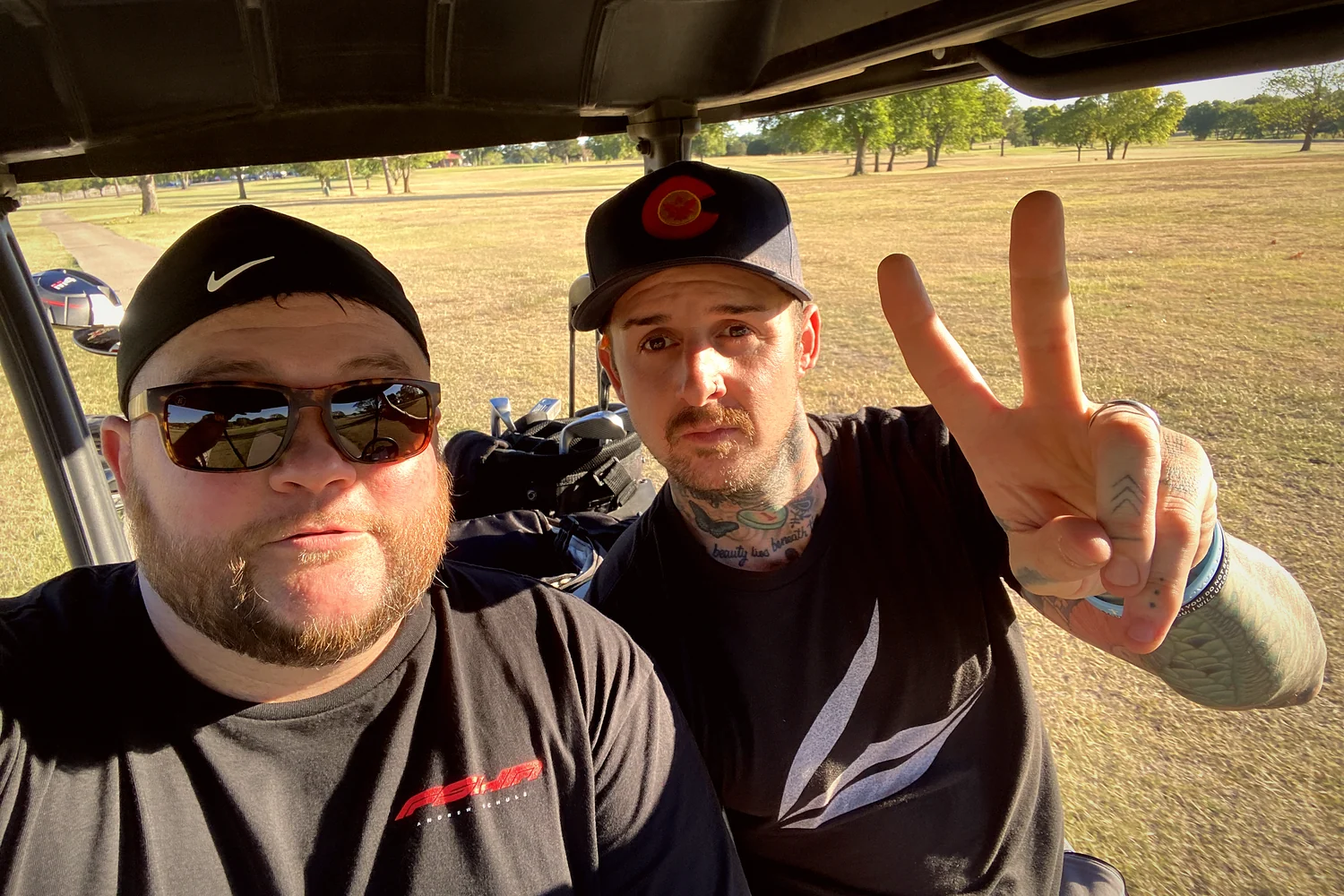 The two founders in a golf cart on a Texas course